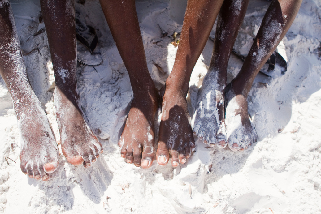 African black feet in white sand